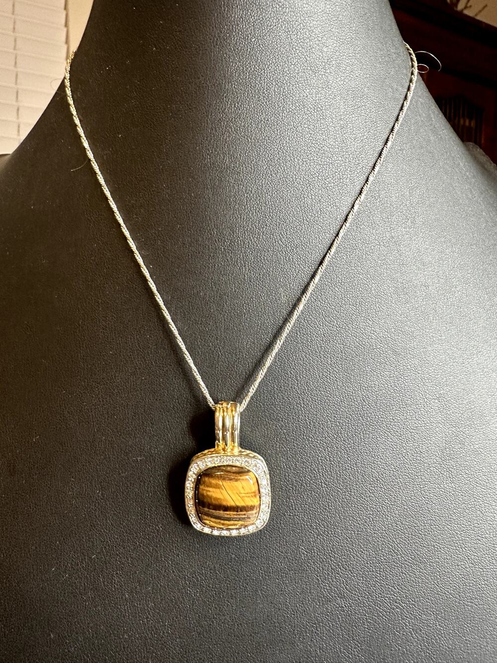 Two tone silver and gold tone Cat eye surrounded by rhinestones magnetic pendant
